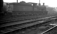 Worsdell veteran class J21 0-6-0 no 65033 on its home shed at 52B, Heaton, on a soaking wet Saturday in February 1961, the year before its withdrawal. The locomotive was subsequently purchased for preservation and is currently at Kirkby Stephen East awaiting major restoration [see image 36091].<br><br>[K A Gray 04/02/1961]