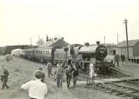 Snappers leaving a special at Tarbolton to find a good vantage point during a photostop on 9 May 1959. The train is the SLS <i>Land o' Burns</i> railtour from Ayr, hauled by 2P 4-4-0 40574, which also visited Catrine and Muirkirk. <br><br>[G H Robin collection by courtesy of the Mitchell Library, Glasgow 09/05/1959]