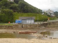 In the mouth of East Row beck at Sandsend there is a support pier reminder of the long, high, wooden, trestle viaduct that took the coast line south shortly after leaving Sandsend station. The line crossed the main coast road immediately after the station, and then ran along the rear of the properties to upper right of view before running onto the curving viaduct high above the road and the previous building to that by the beckside, and then running between coast road and beach en route to Whitby West Cliff station approx 2 miles away.  <br><br>[David Pesterfield 06/08/2017]