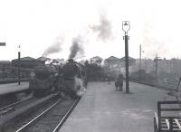 A small group of Saturday morning admirers standing on the platform at Buchanan Street in April 1954. They will soon witness the departure of Black 5 44975 with the <I>Bon Accord</I>  for Aberdeen and BR Standard 5 73008 with a service to Inverness. Both locomotives are Perth based.<br><br>[G H Robin collection by courtesy of the Mitchell Library, Glasgow 10/04/1954]