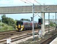 A 4-car 158 combination passing Pelaw heading east towards Sunderland on a bright and sunny 10 July 2004. 158737 is bringing up the rear of the train, with both units sporting the stylish <I>'Northern Spirit'</I> claret/blue livery. Photographed from the South Shields platform of Pelaw Metro station. [Ref query 6 September 2017]<br><br>[John Furnevel 10/07/2004]