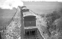 The returning Langholm goods heading south in 1965 behind an unidentified Ivatt 2-6-0. Photographed from the former road bridge a quarter of a mile north of Canonbie station.<br><br>[Bruce McCartney //1965]