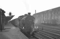 Looking south along platform 1 at Carlisle on a murky 26 October 1964 as Fowler 4F 0-6-0 43953 stands with a parcels train, with loading activity taking place in the background.<br><br>[K A Gray 26/10/1964]
