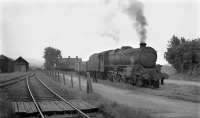 Black 5 45438 undertakes some leisurely shunting at Garstang Town station, probably in the 1950s judging by the amount of traffic still being carried. This view looks east towards the WCML. The old GKER carriage sheds were still standing at this time, albeit trackless. The large house in the background, Beech Mount, is still on Lancaster Rd in Garstang today but everything else in the photo is now covered by a housing development known as Station Way. [See image 60594] for a 1910 diagram of the station site.  <br><br>[Knott End Collection //1955]