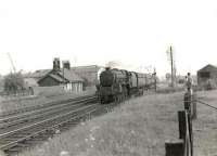A Dumfries - Glasgow stopping train passing Hurlford on 22 May 1951. The train is hauled by Black 5 44718 and observed by a pair of well balanced young enthusiasts on the boundary fence.<br><br>[G H Robin collection by courtesy of the Mitchell Library, Glasgow 22/05/1951]