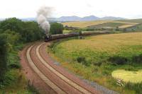 The 11-coach SRPS Railtour from Linlithgow to Tweedbank battles up<br>
Borthwick Bank. Note the old platelayers' hut which has survived through<br>
being located in a private field, rather than within the new railway<br>
footprint where it would have been swept away indiscriminately during<br>
construction works. The field formerly housed extensive sidings for the<br>
dumping of ash from St Margaret's shed.<br><br>[David Spaven 20/08/2017]