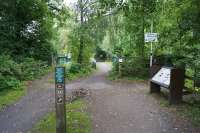 Looking north along the trackbed at the site of the former Middlewood Higher station. The line was finally closed in 1970 and today it has become the Middlewood Way from Rose Hill Marple to Macclesfield. The signs on the right point to the lower station on the Hazel Grove to Buxton line. <br><br>[John McIntyre 03/09/2017]