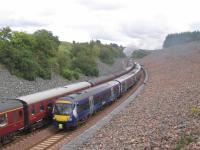 Formed of a 6-car Class 170, the 11.45 Tweedbank-Edinburgh service<br>
coasts down Borthwick Bank  past the southbound SRPS Railtour.<br><br>[David Spaven 20/08/2017]