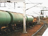 A trainload of empty tanks heading north through Carstairs station in December 2004 on the way back to Grangemouth. At the head of the train is EWS 60002. <br><br>[John Furnevel 02/12/2004]