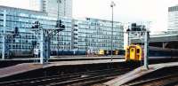 A mid afternoon scene at pre-Eurostar Waterloo. A 4CIG unit in Network South East (NSE) livery waits to depart. In the background is a Class 73 electro-diesel (of the type now to be seen hauling Caledonian Sleepers) in front of a Class 33 both in BR blue. Behind them is a unit of NSE Class 487 stock from 1940 belonging to the Waterloo and City underground line awaiting descent in the Armstrong lift. Originally ordered by the Southern Railway these units were replaced in 1992. London Underground took over the W&C Line (The Drain) in 1994.<br><br>[Charlie Niven 02/09/1988]