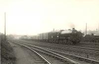 J39 0-6-0 64897 held at signals with a lengthy freight at Cowlairs East Junction on 26 April 1952. The Eastfield breakdown crane stands alongside in the shed yard.<br><br>[G H Robin collection by courtesy of the Mitchell Library, Glasgow 26/04/1952]