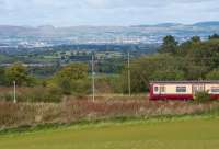 A 318 passes the site of Lyoncross Junction. The lines still pass round the never built island platform. Unfortunately tree growth makes the formation impossible to see at this time of year - but note the odd out of alignment of the catenary.<br><br>[Ewan Crawford 14/09/2017]