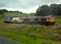 A load of stone from either Arcow or Dry Rigg quarries awaits onward transport North on the S&C. Grab shot from passing train - we'd been shopping in Settle. This rail loading facility opened in June this year.<br><br>[Ken Strachan 02/08/2017]