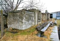 Located 7 miles east of Stainmore Summit on the Trans-Pennine South Durham & Lancashire Union Railway, Bowes was a station that became well used to extremes of weather during its 101 years until closure in 1962. The remains were photographed during a cold blustery wind and persistent rain on 20 March 2010. View is east towards Barnard Castle, with a large farm building now occupying part of the old trackbed.<br><br>[John Furnevel 20/03/2010]