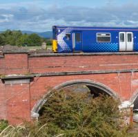It would appear that Network Rail, concerned by the possibility that Waulkmill Glen Viaduct might blow away, have fitted ropes to keep the arches in place. The driver of 314 203 looks on.<br><br>[Ewan Crawford 14/09/2017]
