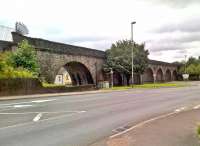 Although Pontlottyn was in coal mining and iron furnace country, the locals in Victorian times couldn't get a pub built, due to restrictive covenants imposed by former landowners. The Rhymney Railway, however, owned the land under its viaduct; so they allowed a pub to be built - under the last two arches at the South end, on the right of this view. The pub lasted until the 1980's, but is now closed and demolished. [Ref query 26 September 2017]<br><br>[Ken Strachan 19/08/2017]