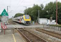 I didn't see many GB registered cars in Southern Belgium so it was a surprise when this Rolls-Royce Silver Cloud drew up at the level crossing barriers. SNCB 08517 slows for the stop at Paliseul station running from Libramont to Dinant on 7th September 2017.<br><br>[Mark Bartlett 07/09/2017]