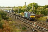 Class 88s have re-appeared on the Mossend-Daventry 'Tescoliner' container trains after a brief absence. 88003 'Genesis' heads south at Balshaw Lane Jct in the early evening of 17 September 2017.<br><br>[John McIntyre 17/09/2017]