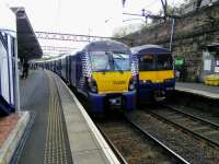 Edinburgh (left) and Balloch services cross at High Street on 19 September 2017.<br>
<br>
<br><br>[David Panton 19/09/2017]