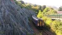 A shot of the 12 11 service to Glasgow Queen Street climbing out of Oban on Sunday 10th September 2017 on the way to Glencruiten. The Sprinter is passing Soroba and some pretty impressive rock netting.<br><br>[Brian Smith 09/09/2017]