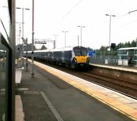 An Edinburgh service enters Uphall on 25th September 2017. The proximity of the station to the M8 Motorway is clear. Uphall has no footbridge, and the road bridge is some way off to the west of the station. Consequently it must have the longest walk between platforms in Scotland.<br>
<br>
<br><br>[David Panton 25/09/2017]