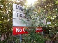 The British Rail Helvetica typeface dates this one. 'Millerhill Freight<br>
Services T & R S Stores' Whatever they were (and please don't tell me) they<br>
are surely not there now. The June 2012 pass of the Google Street View<br>
camera shows that there was a steam loco road sign here then, but it's not<br>
there now. Also, somebody thought this was the ideal place to pitch up tent.<br>
<br>
<a href=https://www.google.co.uk/maps/@55.9148381,-3.0801154,3a,49.<br>
2y,103.58h,88.09t/data=!3m6!1e1!3m4!1syZjJMi_qnGIc71WfEntt_g!2e0!7i13312!<br>
8i6656>See the tent on Google Streetview.</a><br><br>[David Panton 15/09/2017]