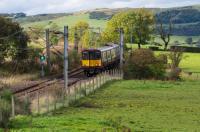 The rural nature of the last few miles of the Neilston branch are obvious in the view. 314 206 is heading for Glasgow passing the site of Netherton Goods, which was on the left.<br><br>[Ewan Crawford 28/09/2017]