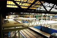 An unusual vantage point at Waverley in August 2006, courtesy of the temporary bridge over platform 19 which provided a route between the station and Princes Mall. View is east showing work in progress on what would become the upgraded entrance from Waverley Steps, linking with the new escalators still to be installed on the western concourse. Running beyond the new bridge is the connection with the cross-station walkway leading to the south side platforms and the Market Street entrance. Up above is part of the justification for the subsequent roof panel replacement project [see image 36223].<br>
<br><br>[John Furnevel 05/08/2006]