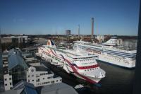 Seen from the adjacent hotel are MS <I>Baltic Queen</I> of Tallink and <I>Silja Serenade</I> of Silja Line are berthed together in Stockholm's ferry haven. These are regular ferries not cruise liners which ply between Sweden, Finland and the Baltic States. In the centreground, under construction, is a woodchip-fired power station to which raw material is brought by ship or by train. The line which serves it can just be made out in the shady area to the left of and below the new road infrastructure. There was a station, Värta, on this route, Värtabanan, until 1913. The line itself was electrified between 1904 and 1908 and re-electrified in the 1930s; now it is freight only. According to the Port website there have been occasional train ferries to Finland.<br><br>[Charlie Niven 16/03/2014]