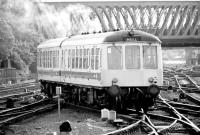 A 2-car DMU on Hull shuttle duty crossing over the pointwork just to the south of York station in the summer of 1980, with Holgate Road bridge forming the backdrop. <br><br>[John Furnevel 22/07/1980]