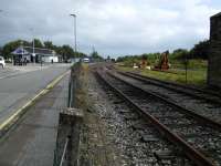 Although the preserved Keith and Dufftown Railway is very much still alive it has been many years since the line reached Keith Junction (in distance) and the track you see finishes just behind me. It starts up again just before Keith Town station a few hundred yards away. The platform face is still there however and is reasonably maintained - it even has planters. The track shows light use, probably as an engineers' siding. Keith station with its single track can be seen to the left.<br><br>[David Panton 26/09/2017]