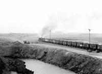 A pair of hard working NCB Pugs climbing away from Polkemmet Colliery on a grey and misty February morning in 1972 with a trainload of coal for the BR exchange sidings on Polkemmet Moor.<br><br>[John Furnevel 11/02/1972]