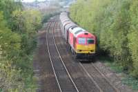 DBS 60054 passing the site of the original Pyle station, which closed in 1886, with a Margam to Llanwern train of steel coil. The footbridge is the original bridge which would have been at the west end of the platforms. The rear of the train has just passed the current station at Pyle (its third location) which opened in 1994.<br>
<br>
<br><br>[Alastair McLellan 03/10/2017]