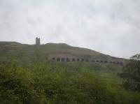 View from near Florence Terrace looking south east to the remains of the former Calcining Kiln at Rosedale East, with the former trackbed running in front of the structure.<br><br>[David Pesterfield 24/09/2017]