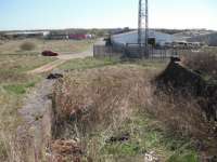 I am standing with my back to the existing Ayr line facing east. Below me is the trackbed of the Doura branch where it passed under the Ayr line. The extended abutments at one time carried the connections from the Ayr line into Eglinton Ironworks.<br><br>[Douglas Blades //2017]