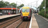 An early afternoon service to Larkhall, formed by unit 334026, calls at Blantyre platform 2 on 18 August 2006. At this time both the station and the train are carrying SPT colours.<br><br>[John Furnevel 18/08/2006]