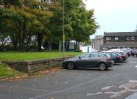 The original L&PJ station in Lancaster was only used by passengers from 1840 to 1849 but most of its site continued in use as the city's railway goods depot until the 1960s. This goods platform has survived the redevelopment of railway land as the hospital car park. The old passenger station is at the end of the grey building to the right of the trees [See image 18309]. [Ref query 13 October 2017] <br><br>[Mark Bartlett 13/10/2017]