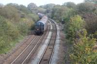 A loaded Margam to Llanwern steel coil train climbing Stormy Bank behind DBS 60054 on 3rd October 2017. The train is passing the site of the former Pyle Junction station. Nothing remains of Pyle Junction, which formed the east end of the triangle for the Porthcawl branch. It opened in 1886 and closed 1965.<br>
<br>
<br><br>[Alastair McLellan 03/10/2017]