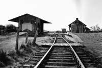 A view of Garstang Town station, probably from the early 1960s. The distinctive narrow station building with the slightly wider signal box at the far end [See image 61091] is on the island platform, which in passenger carrying days was accessed by a footbridge. Beyond and to the right is the old GKER engine shed, later dismantled and rebuilt nearby as a farm building. Straight ahead is the water tower with the small goods shed on the left. Final closure came in 1965 and the site is now covered by a housing development known as Station Way.  <br><br>[Knott End Collection //]