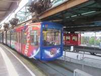 Cars stopped at a station on the Wuppertal, showing the suspension of the cars.<br><br>[John Yellowlees 15/09/2017]