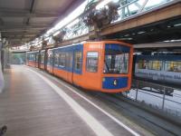 An apparently IRN Bru themed car enters a station on the Wuppertal.<br><br>[John Yellowlees 15/09/2017]
