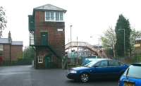 The impressive looking signal box at Prudhoe, Northumberland, on a damp and overcast morning in May 2006. View is east towards Newcastle from the station car park, with the platforms beyond the level crossing.<br><br>[John Furnevel 07/05/2006]