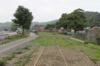 With the railway closed for nearly thirty years it is inevitable that the local population will create some unofficial crossing points of the unused tracks. This is the scene at Hastiere in Southern Belgium, taken from the north end of the station limits. The station itself [see image 60943] can just be seen beyond the pile of pipes. 7th September 2017.<br><br>[Mark Bartlett 07/09/2017]