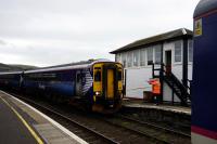 A tablet-exchange at Girvan. The 11.59 for Kilmarnock (from Stranraer) drops the tablet for the section from Barrhill, which will then be given to the driver of the 12.01 to Stranraer. The driver of the 12.01 explained that these days the handover has to be from the train once it has halted. No more hanging it on the signalman's arm as the train runs past.<br>
<br><br>[Colin Miller 14/10/2017]