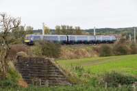 A Stirling-Glasgow service at Larbert Junction on the curve to Carmuirs West. In the foreground is a remaining parapet of the former Denny Branch line.<br><br>[Ewan Crawford 08/10/2017]
