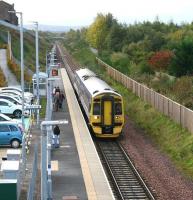 A dull, grey October morning at Newtongrange, with the 0930 from Tweedbank about to call on its way to Edinburgh. The pathway on the left leads to the National Mining Museum, visible top left.<br><br>[John Furnevel 12/10/2017]