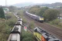 70807 waits to enter Briton Ferry Yard with the Chirk Kronospan Colas Rail to Baglan Bay (Colas) empties as another unidentified Colas Class 70 shunts empties in the yard on 18th October 2017. A Swansea to Paddington HST passes on the main line.<br>
<br>
<br><br>[Alastair McLellan 18/10/2017]