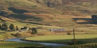 A First TPE Class 185 is almost lost in the landscape as it heads south skirting the upper reaches of the River Clyde on the approach to Abington on 20 October 2012.<br><br>[John McIntyre 20/10/2012]