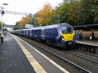 A Helensburgh service calls at Garrowhill on 14 October 2017. Formerly Garrowhill Halt it retains its halt-like ticket office at Street level.<br>
<br>
<br><br>[David Panton 14/10/2017]