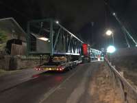 The sections of the Baillieston temporary pedestrian and services bridge together with its north supporting tower have arrived at the site and are waiting for OHLE isolation and the start of the possession before lifting commences.<br><br>[Colin McDonald 29/10/2017]